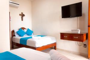 Postel nebo postele na pokoji v ubytování Hotel Bacalar Magico