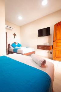 Postel nebo postele na pokoji v ubytování Hotel Bacalar Magico