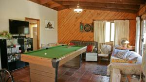 a living room with a pool table in it at Nutley Cottage with river view Bermagui Linen provided in Bermagui