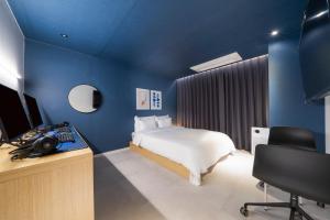 Postel nebo postele na pokoji v ubytování Croissant Hotel Guri by Aank