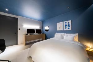 Postel nebo postele na pokoji v ubytování Croissant Hotel Guri by Aank