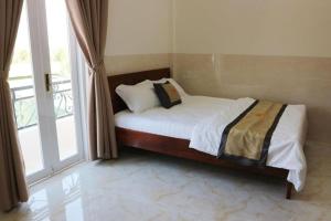 Postel nebo postele na pokoji v ubytování Magnolia Hotel Cam Ranh