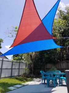 a colorful kite hanging over two tables and chairs at My Nautical Paradise in Miami in Miami