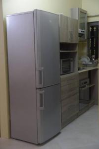 een roestvrijstalen koelkast in een keuken bij Private home in Flic en Flac - quiet location in Flic-en-Flac