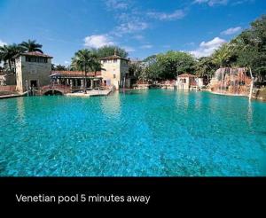 a large pool of blue water with buildings and trees at Sol Miami # 2 with free parking in Miami