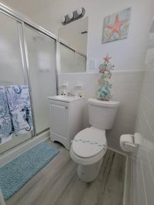 a bathroom with a toilet and a sink and a shower at Sol Miami # 2 with free parking in Miami