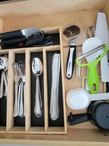 a wooden drawer with utensils in it at Sol Miami # 2 with free parking in Miami