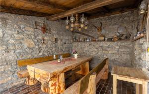 a dining room with a wooden table and benches at 3 Bedroom Awesome Home In Jurdani in Jurdani