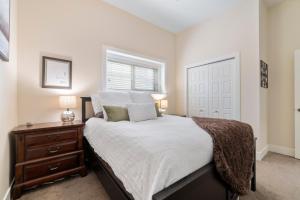 1 dormitorio con 1 cama, vestidor y ventana en Oh What A View! - Lower Suite en Vernon