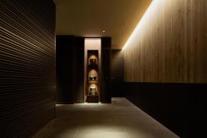a hallway with a lighted wall and a hallway with at Hotel Gracery Shinjuku in Tokyo