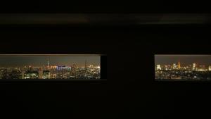 a view of a city at night from a window at Hotel Gracery Shinjuku in Tokyo