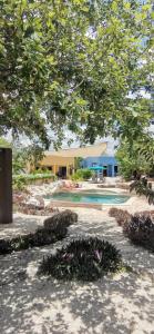 a swimming pool in a yard with a building at VILLA DEL CIELO TIXPEHUAL in Tixpehual