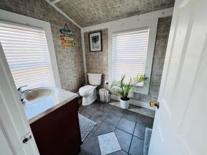 a bathroom with a toilet and a sink at Alwaves Family 3 Bedroom Beach Apartment in Wildwood +13 photos