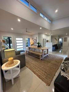 a living room with a couch and a table at Lily Pad Beach House in Agnes Water