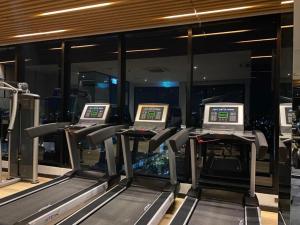 a gym with three treadmills in a building at The Astra Sky River Chiangmai_Sky pool_Old City in Chiang Mai