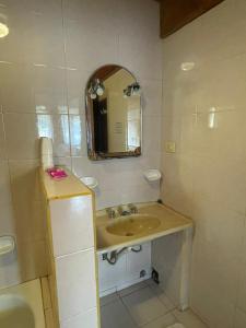 a bathroom with a sink and a mirror at Hosteria La Chacra Moto Friendly in Esquel +33 photos