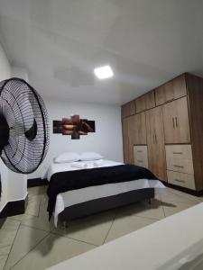 a bedroom with a bed and a fan at Apartamentos Florida Nueva estadio in Medellín