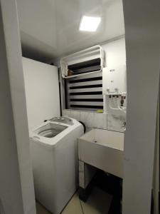 a small white bathroom with a sink and a toilet at Apartamentos Florida Nueva estadio in Medellín