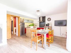 a kitchen and dining room with a table and chairs at Charmant T3 centre de Saint Lary Soulan pour 11 personnes - FR-1-296-469 in Saint-Lary-Soulan +4 photos