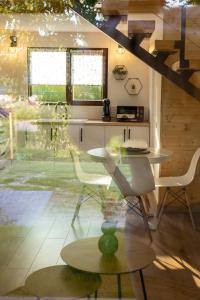 a kitchen with a glass table and white chairs at MILLAR's in Sovata