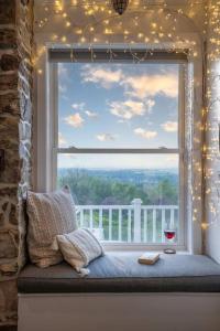 a window with a wine glass and a window with lights at Zen Mountainside Retreat - Spa & Amazing Views! in Hagerstown