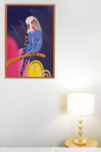 a table with a lamp and a painting on the wall at Winding Creek Cottage in Bald Knob