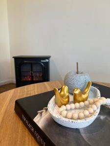 a table with a book and a bowl with a pumpkin and eggs at Winding Creek Cottage in Bald Knob +14 photos