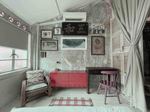 a room with a red desk and a chair at Artist Heritage Penang UNESCO Home (Lebuh Armenian) in George Town