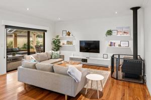 a living room with a couch and a tv at Kalima Retreat - The Ultimate Uncomplicated & Relaxing Holiday! in Dunsborough