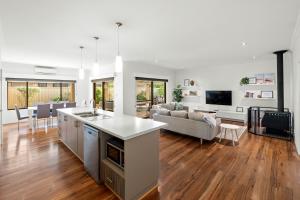 a kitchen and living room with a couch and a table at Kalima Retreat - The Ultimate Uncomplicated & Relaxing Holiday! in Dunsborough
