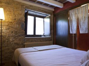 A bed or beds in a room at Masia el Puig