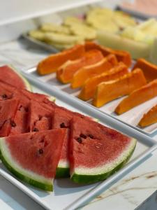 a plate of watermelon and cantaloupe slices at Flamingo Beach Pousada in Cabo Frio