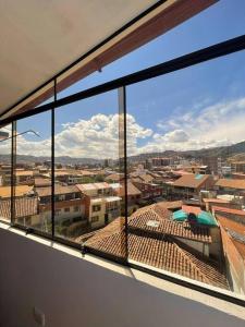 a view of a city from a window at Departamento con vista panoramica in Cusco