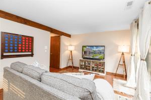 a living room with a couch and a tv at Mother's Day Special! King Beds, Pool Access, Fireplace, Great Location in Galena Territory on Lake Galena in Galena