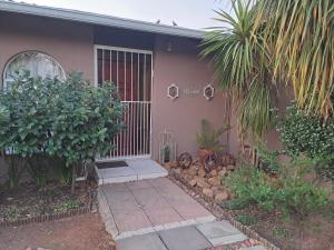 a house with a gate on the side of it at Berlydai Guest Accomodation in Secunda