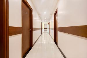 a corridor of a hospital with wooden doors and white walls at Hotel Resida Elite Service Apartments Near Manipal hospital in Bangalore
