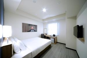 a hotel room with a bed and a television at Travelodge Kyoto Shijo Kawaramachi in Kyoto