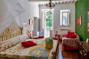 a bedroom with two beds and a living room at Il Casale Di Villa Rossi in Lucca
