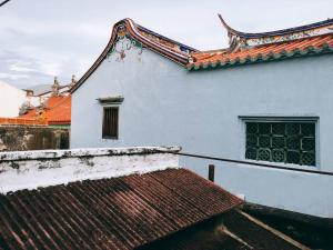 a white building with a roof and a window at Soo Hong (off Lebuh Armenian) penang heritage in George Town