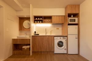 a kitchen with a washing machine and a sink at Luxury hanok with private bathtub - SW12 in Seoul