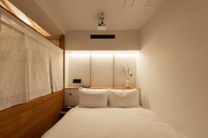 a bedroom with a bed with white sheets at Luxury hanok with private bathtub - SW12 in Seoul