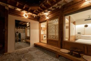 a room with a bed and a window and a room with a bed sidx sidx at Luxury hanok with private bathtub - SW12 in Seoul