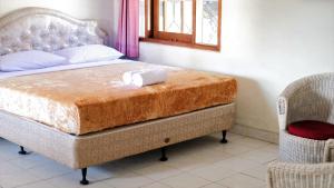 a bedroom with a bed with a towel on it at 3BR AC Rumah Liburan Pasteur Bandung in Bandung