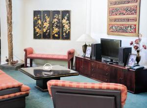 a living room with a couch and a tv at 3BR AC Rumah Liburan Pasteur Bandung in Bandung
