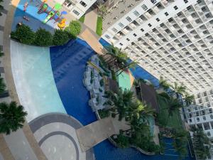 an overhead view of a swimming pool in a resort at SMDC Shore Residences 1 Mall of Asia Complex Pasay in Manila