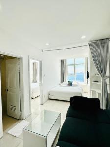 a living room with a couch and a bed at Infinity Sea View Apartment in Nha Trang