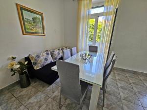 a dining room with a table and a couch at Apartment Nina Marie in Split