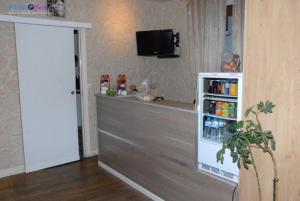 a kitchen with a counter and a refrigerator with drinks at Hotel Les Arcades in Rouen +43 photos