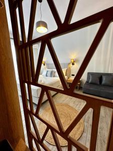 a view of a bedroom through a glass window at Thea comfy living in Nea Vrasna