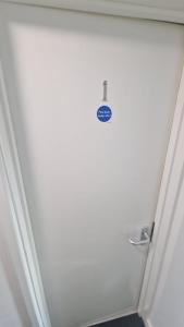 a door with a sign on it in a bathroom at The AppleTree in West Drayton